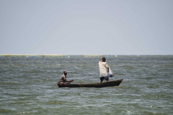 Two men on a small boat on Lake Victoria.