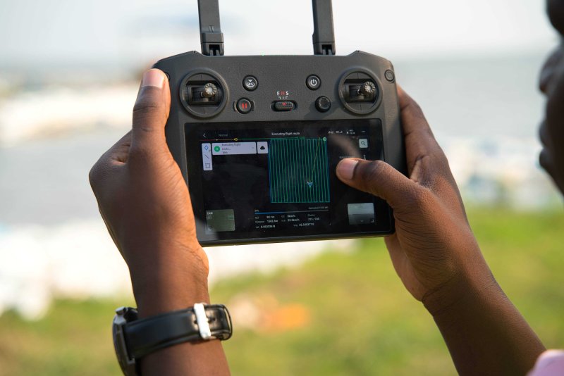 A drone controller in a pilot's hands.