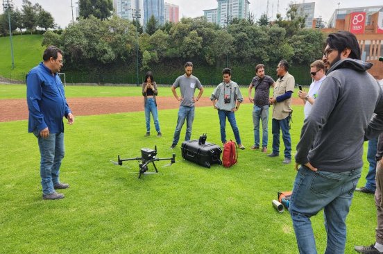 The Mexico Flying Labs team stands outside around a Mavic 3 Enterprise drone, preparing for their mapping mission.