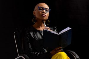 Woman (Barbs) sitting while reading a book