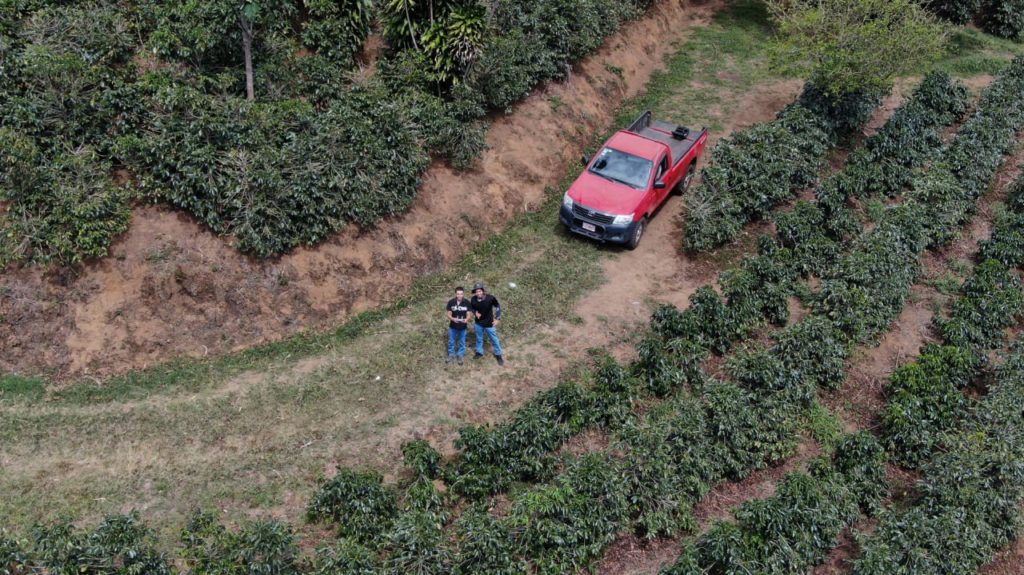 drone shot of team members and a red truck