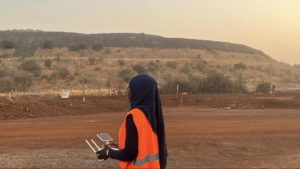 female hijabi drone pilot flying